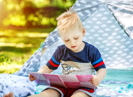 Normal_a-little-kid-reads-a-book-in-the-park-boy-prescho-2025-03-15-05-30-55-utc